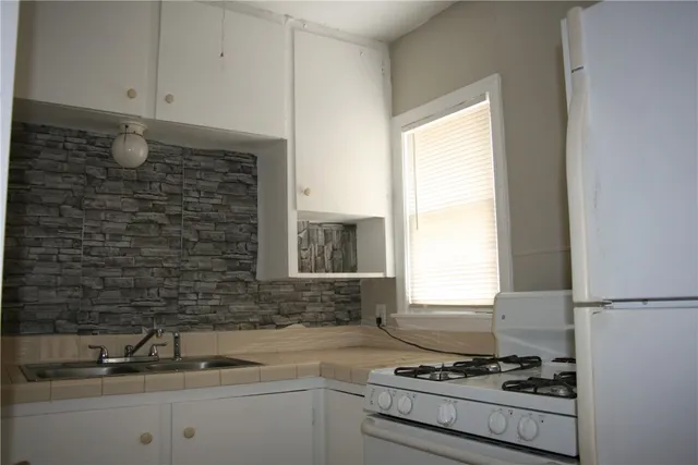 a kitchen with a sink cabinets and window