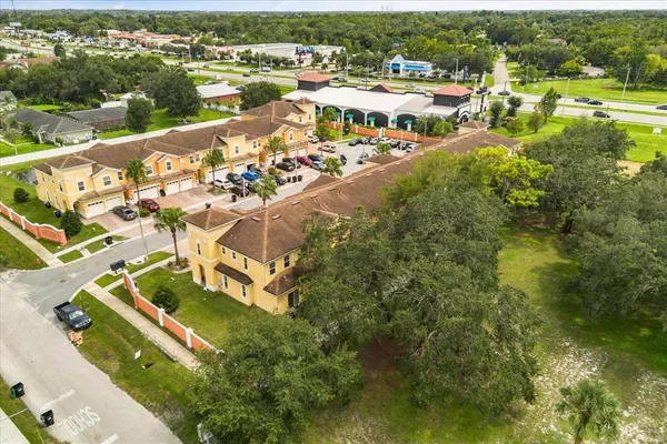 an aerial view of residential houses with outdoor space and river