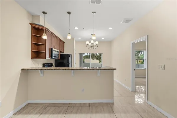 a view of a kitchen with a sink and chandelier