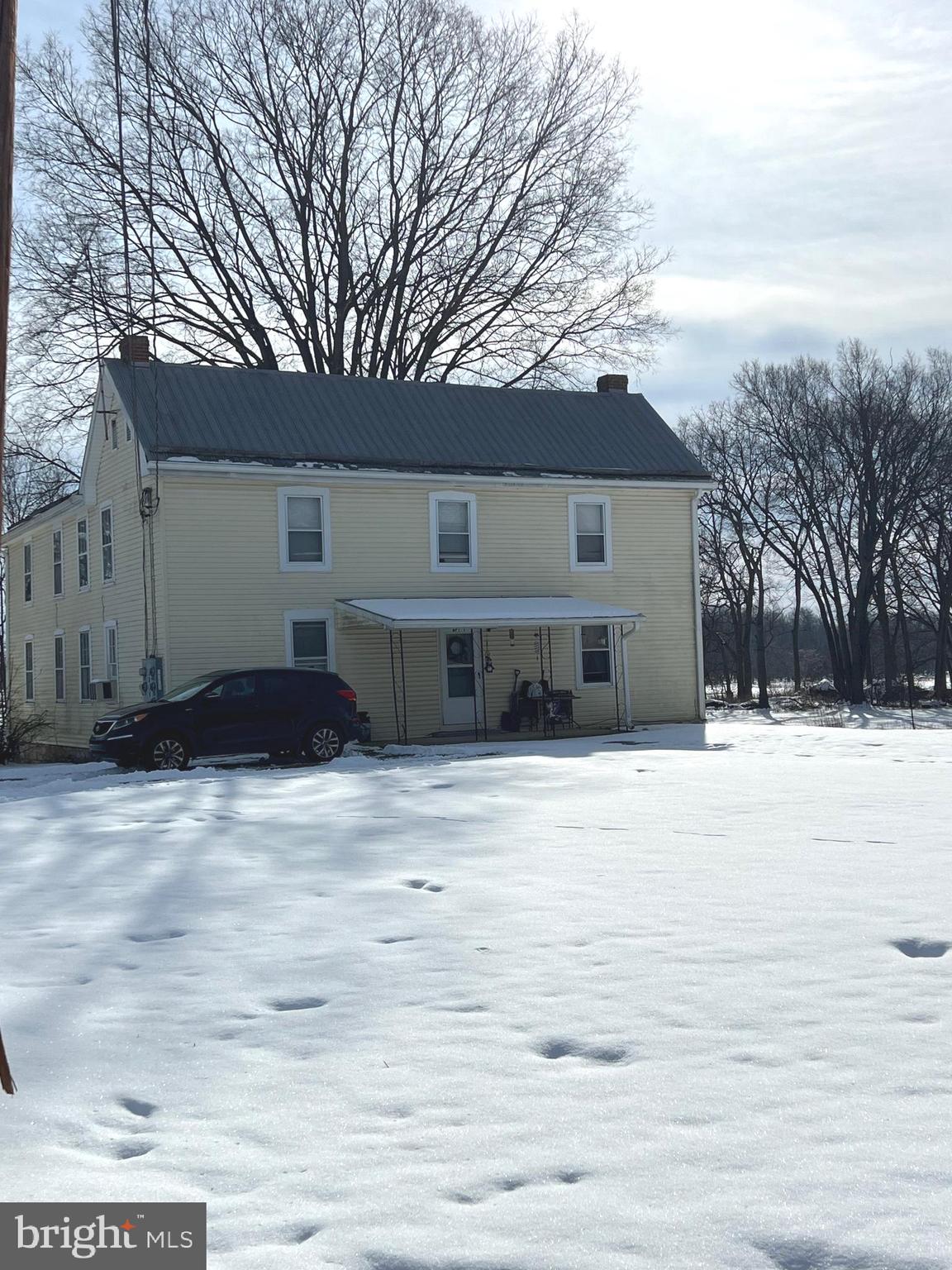 1354 Wiltshire Road, Unit 2 Kearneysville, WV 25430 - Photo 1 of 6 a view of a house with a snow in the yard