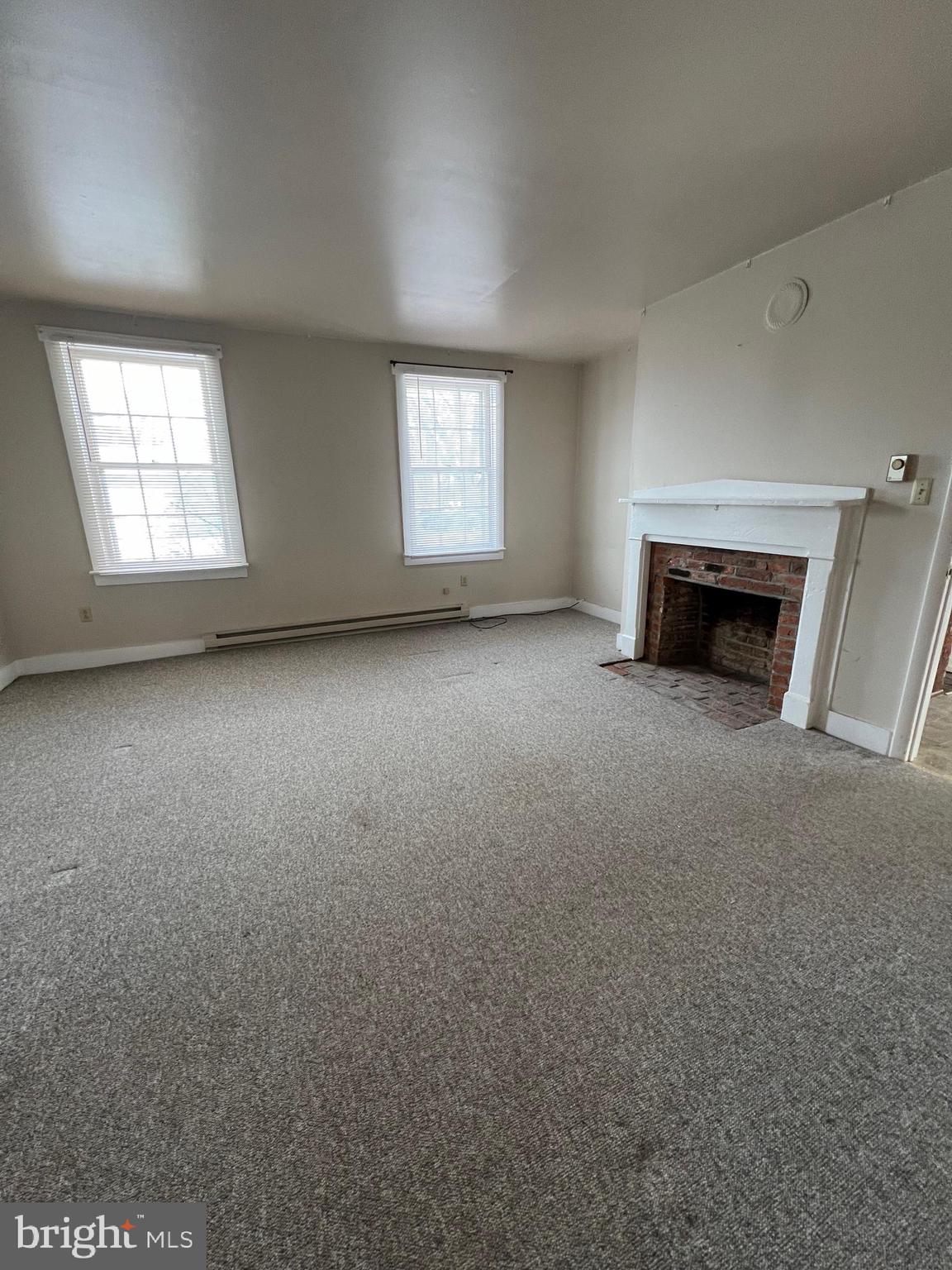 1354 Wiltshire Road, Unit 2 Kearneysville, WV 25430 - Photo 3 of 6 an empty room with fireplace and windows