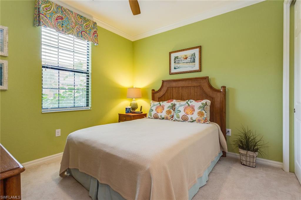 9082 Capistrano Street North, Unit 485 Naples, FL 34113 - Photo 12 of 16 a bedroom with a bed and a window