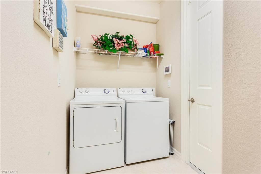 9082 Capistrano Street North, Unit 485 Naples, FL 34113 - Photo 14 of 16 a utility room with dryer and washer
