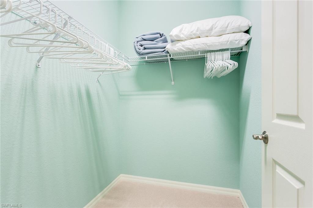 9082 Capistrano Street North, Unit 485 Naples, FL 34113 - Photo 10 of 16 a bathroom with a sink and mirror