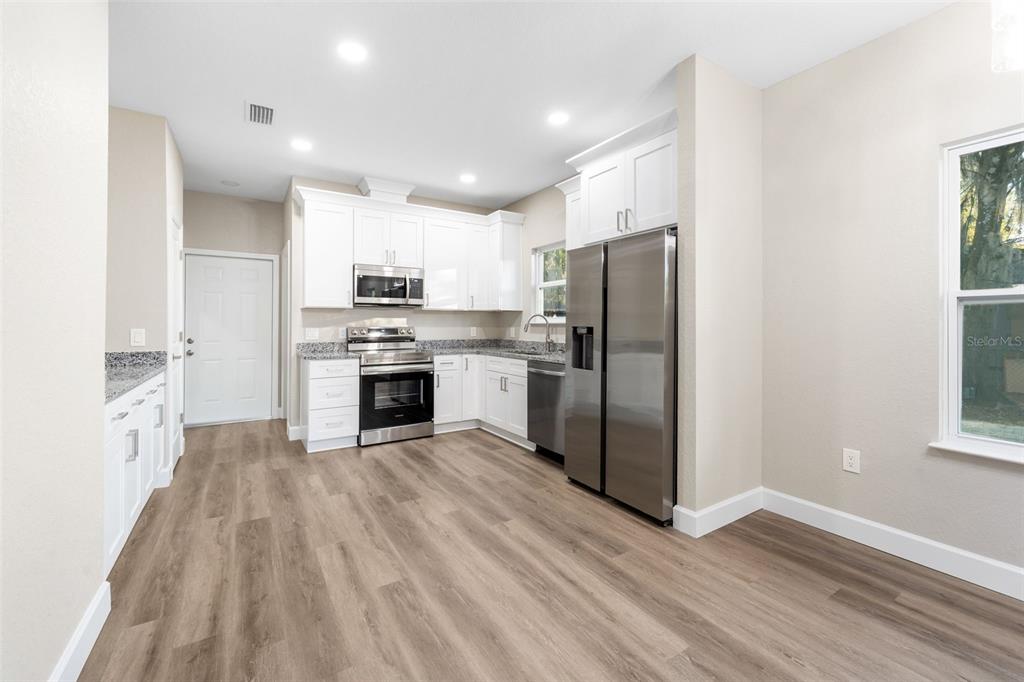 2016 Northeast 3rd Avenue Gainesville, FL 32641 - Photo 12 of 35 a kitchen with stainless steel appliances a refrigerator sink and cabinets
