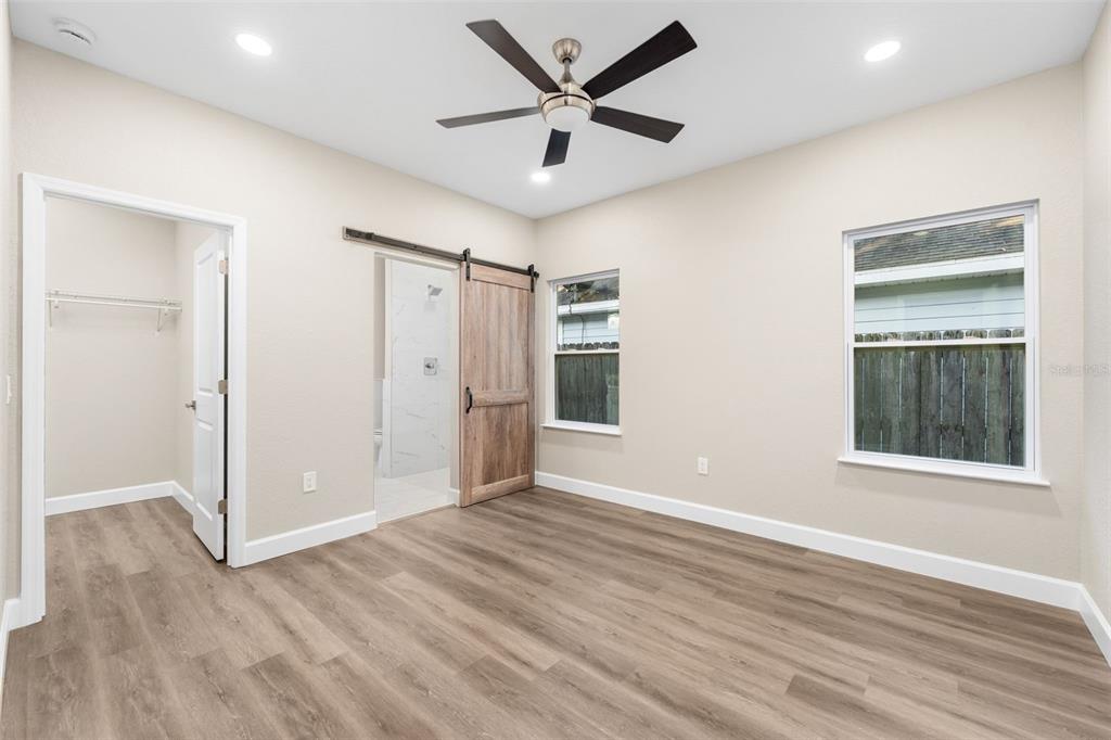 2016 Northeast 3rd Avenue Gainesville, FL 32641 - Photo 16 of 35 a view of an empty room with wooden floor and a window