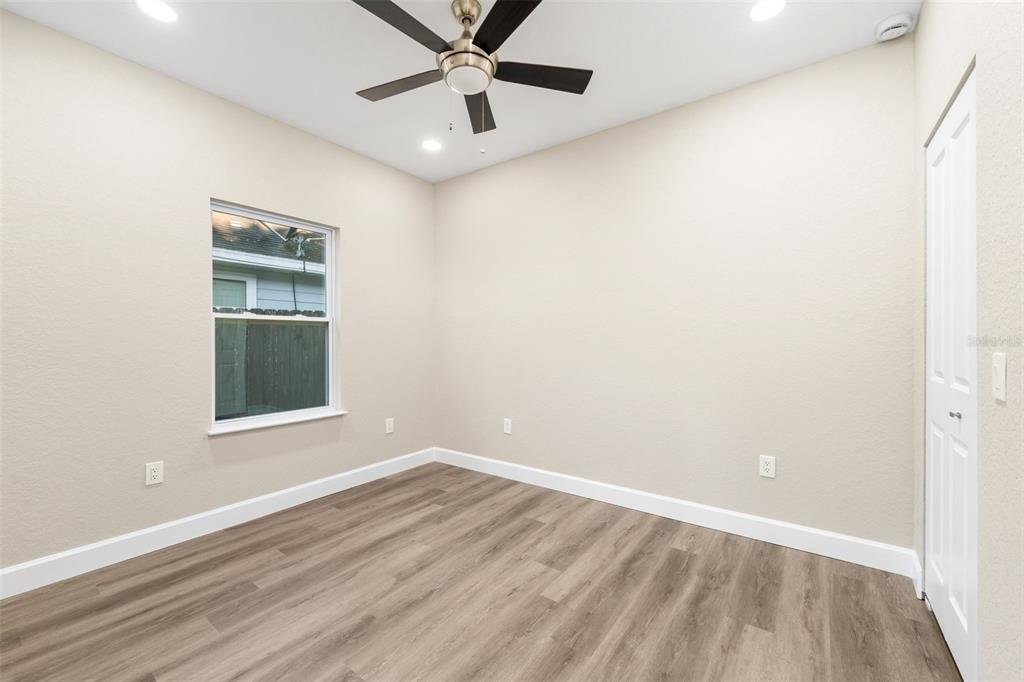 2016 Northeast 3rd Avenue Gainesville, FL 32641 - Photo 22 of 35 an empty room with a window and a ceiling fan