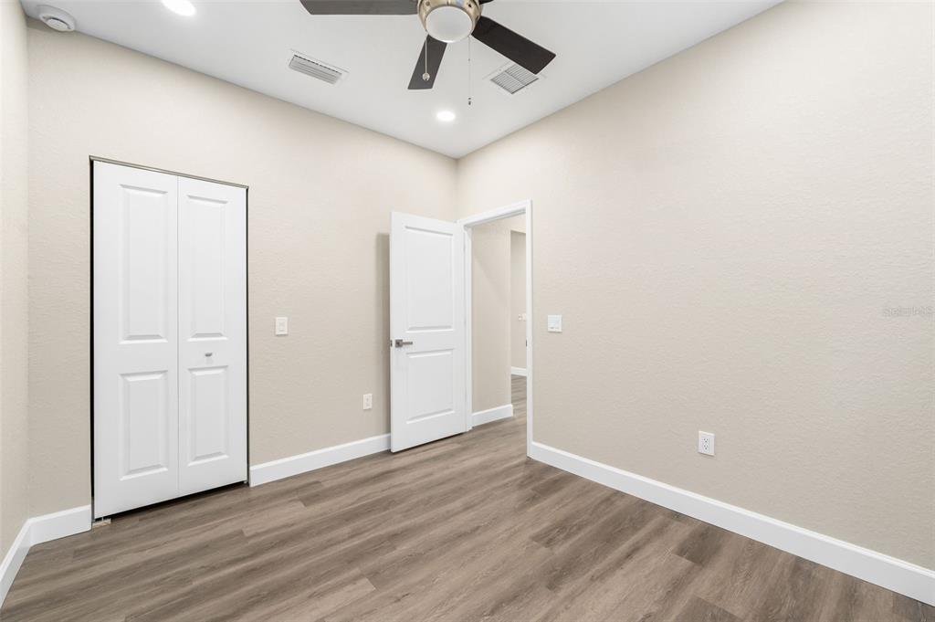 2016 Northeast 3rd Avenue Gainesville, FL 32641 - Photo 23 of 35 an empty room with wooden floor and ceiling fan
