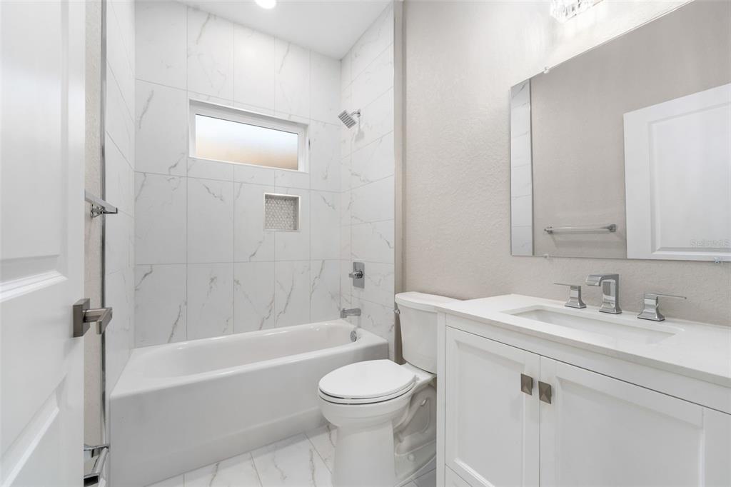 2016 Northeast 3rd Avenue Gainesville, FL 32641 - Photo 3 of 35 a bathroom with a sink toilet and shower