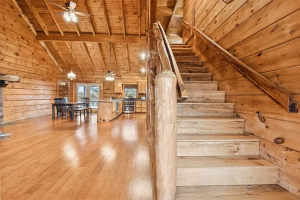 a view of entryway and hall with wooden floor