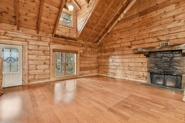 a view of an empty room with a fireplace and a window