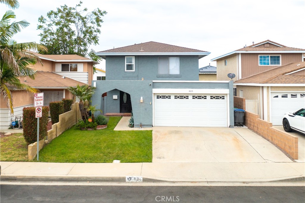 a view of a house with a yard and sitting area