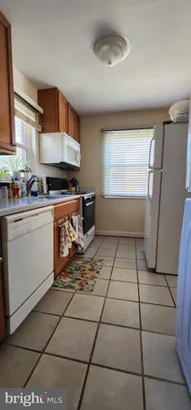 a kitchen with stainless steel appliances a sink a stove a refrigerator and cabinets