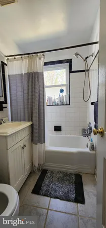 a bathroom with a tub a sink and a shower