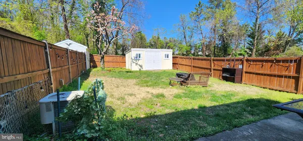 a view of a backyard with wooden fence