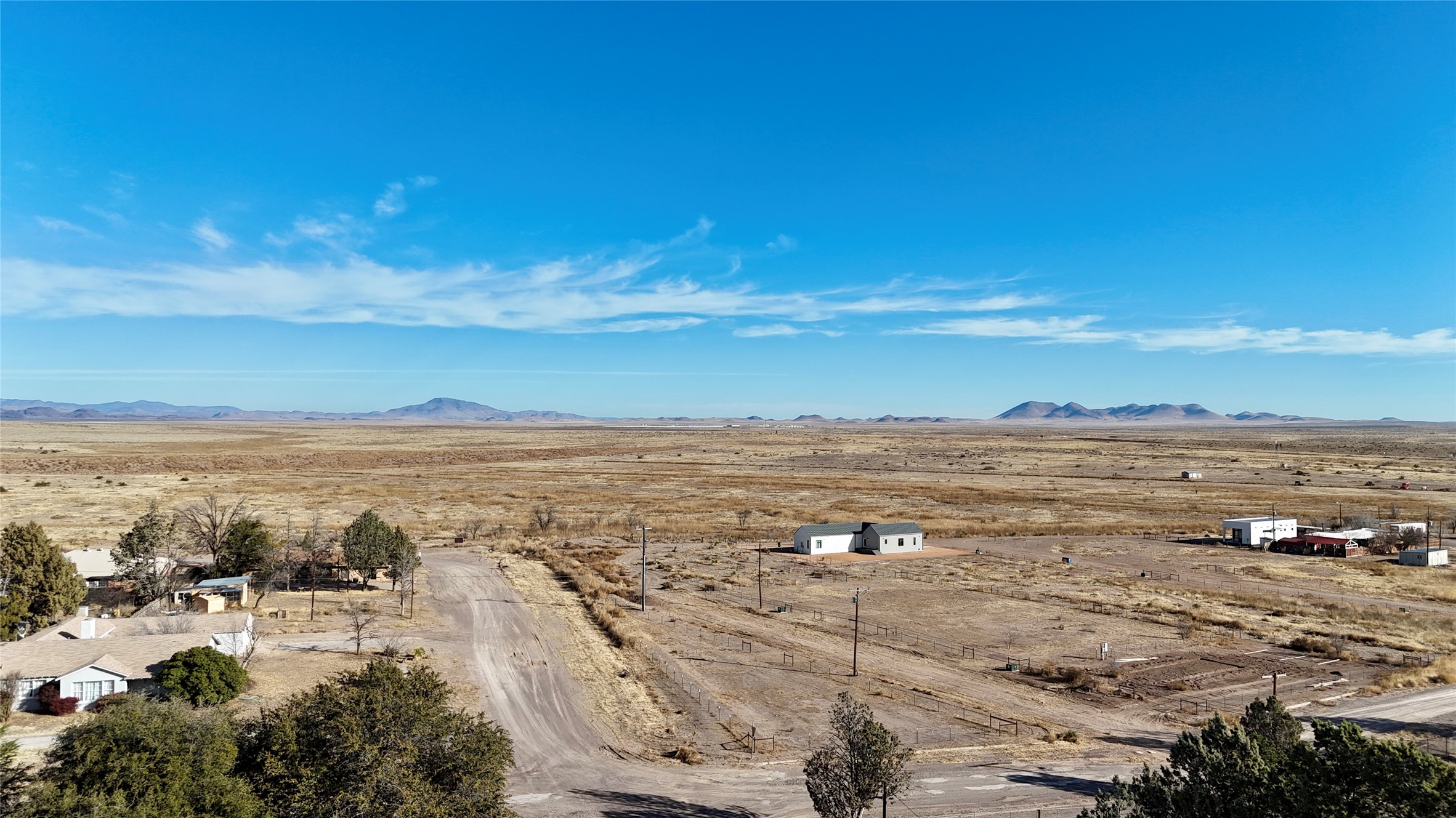 Overview of rural landscape featuring a mountain backdrop and a desert landscape