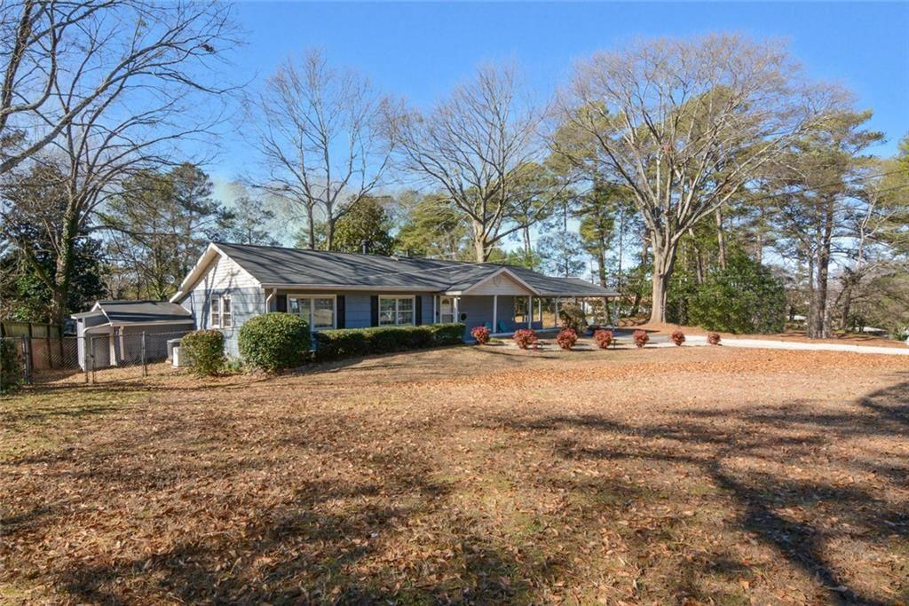 3206 Laventure Drive Chamblee, GA 30341 - Photo 33 of 39 a front view of a house with a yard and trees