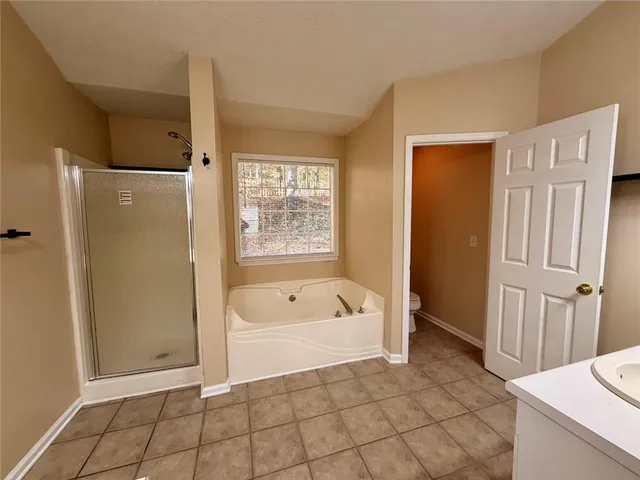 a bathroom with a bathtub sink and toilet