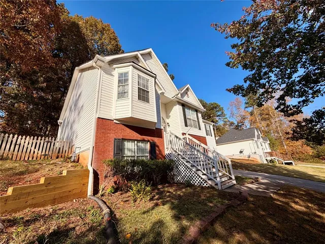a view of a white house with a yard