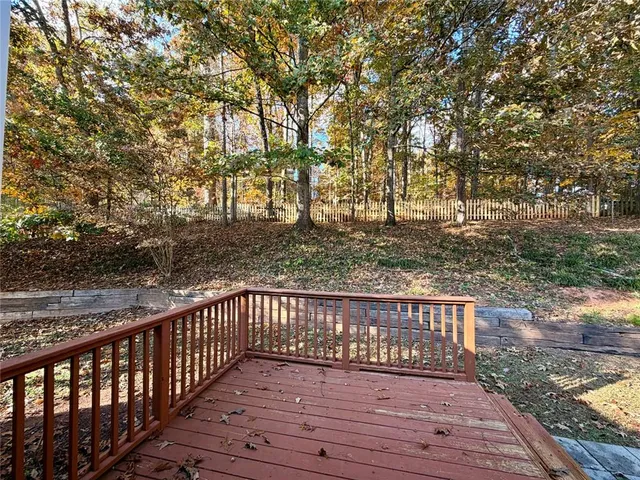a view of a yard with wooden fence
