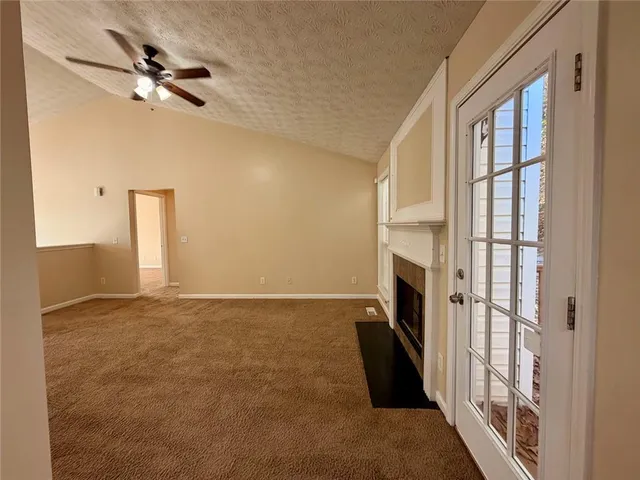 a view of an empty room with a fireplace