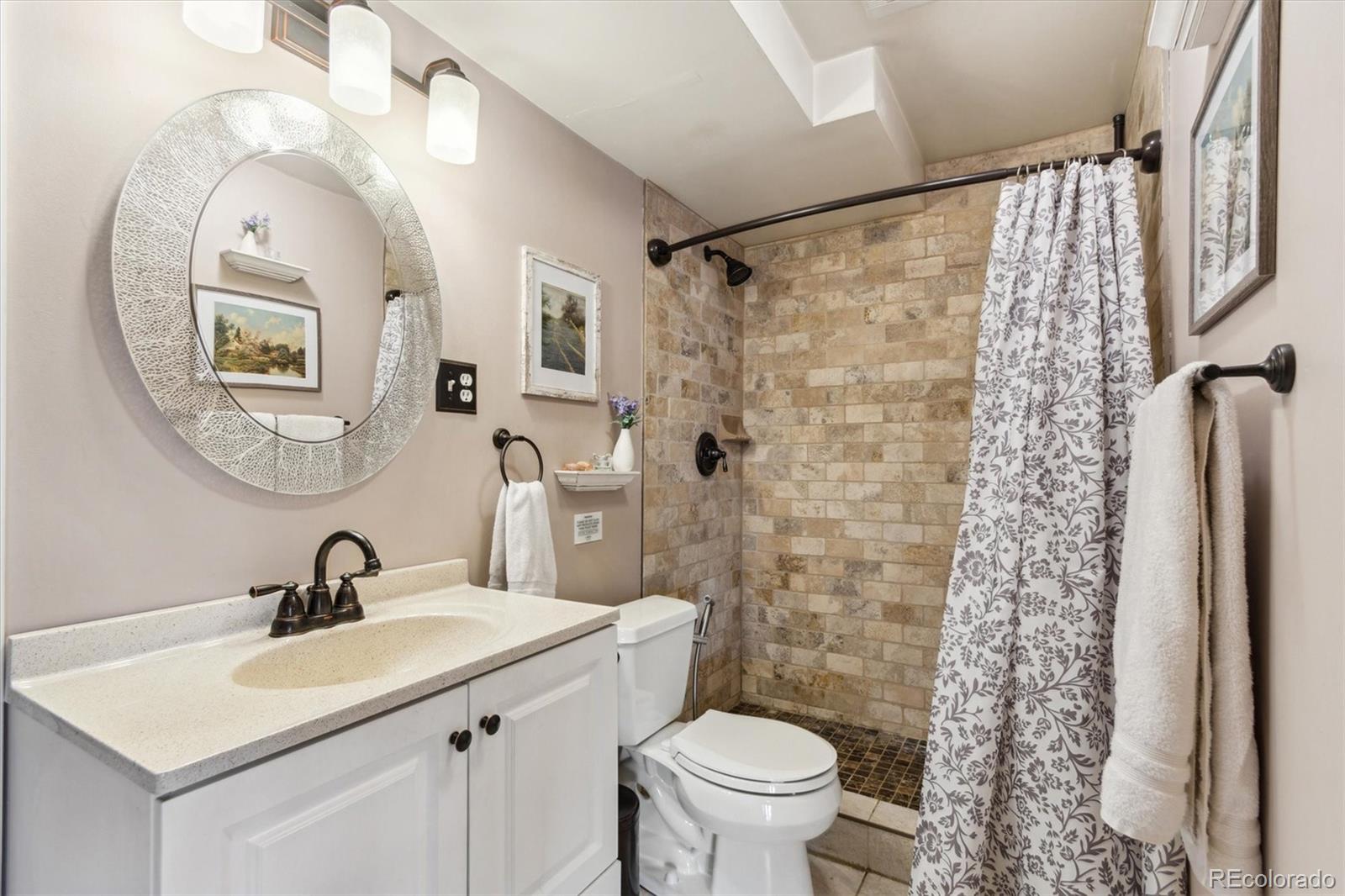 779 Aspen Way Evergreen, CO 80439 - Photo 13 of 49 a bathroom with a sink a toilet and a mirror