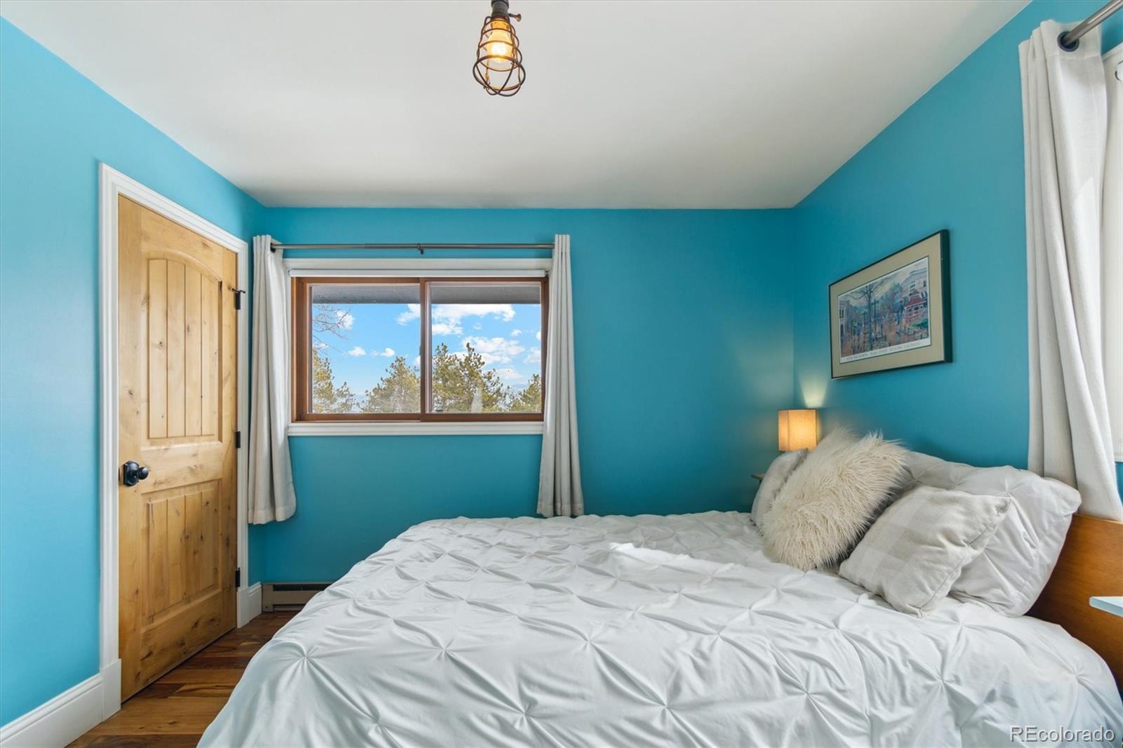 779 Aspen Way Evergreen, CO 80439 - Photo 17 of 49 a bedroom with a bed and a window
