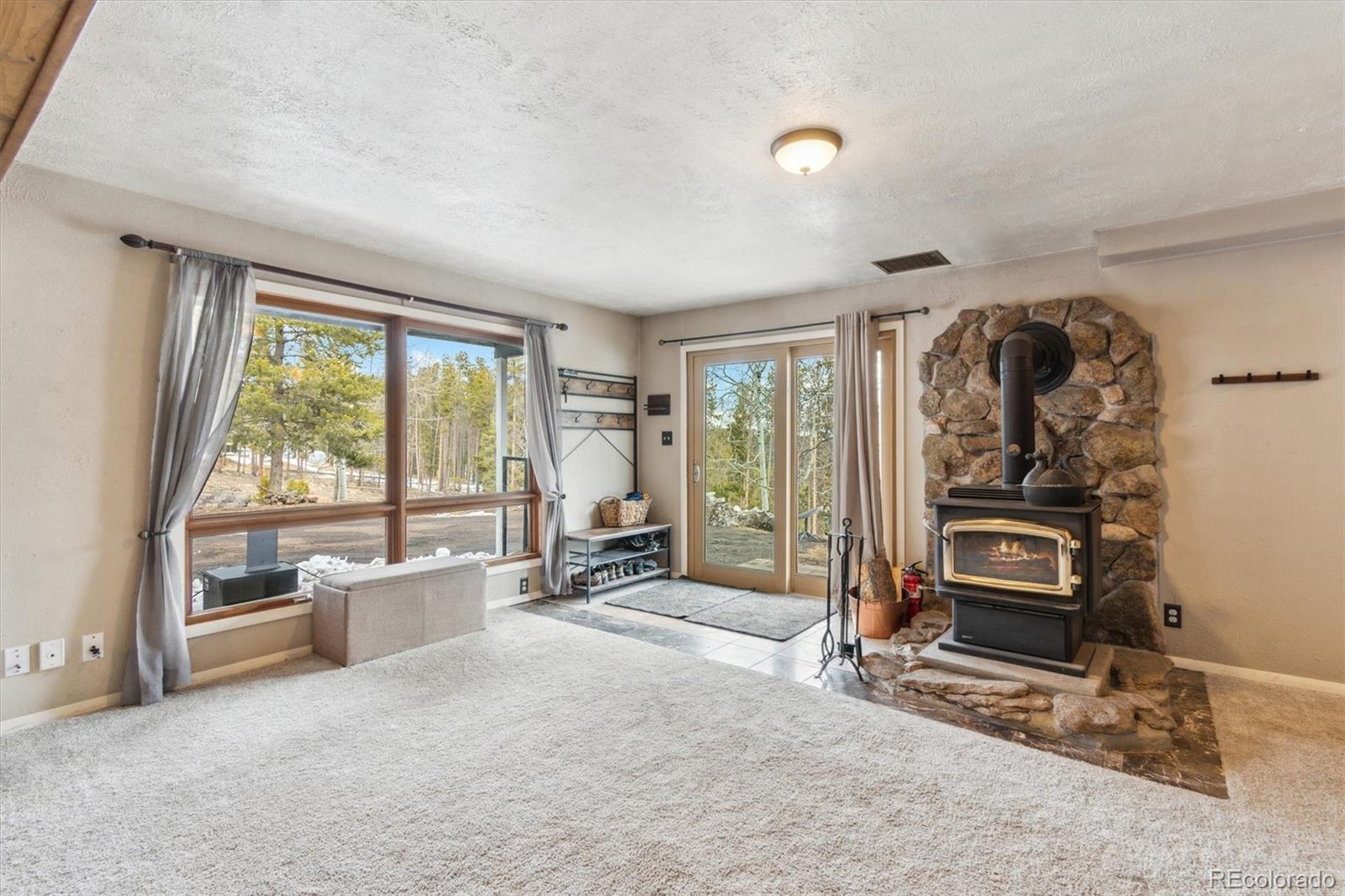 779 Aspen Way Evergreen, CO 80439 - Photo 20 of 49 a view of a livingroom with furniture and floor to ceiling window