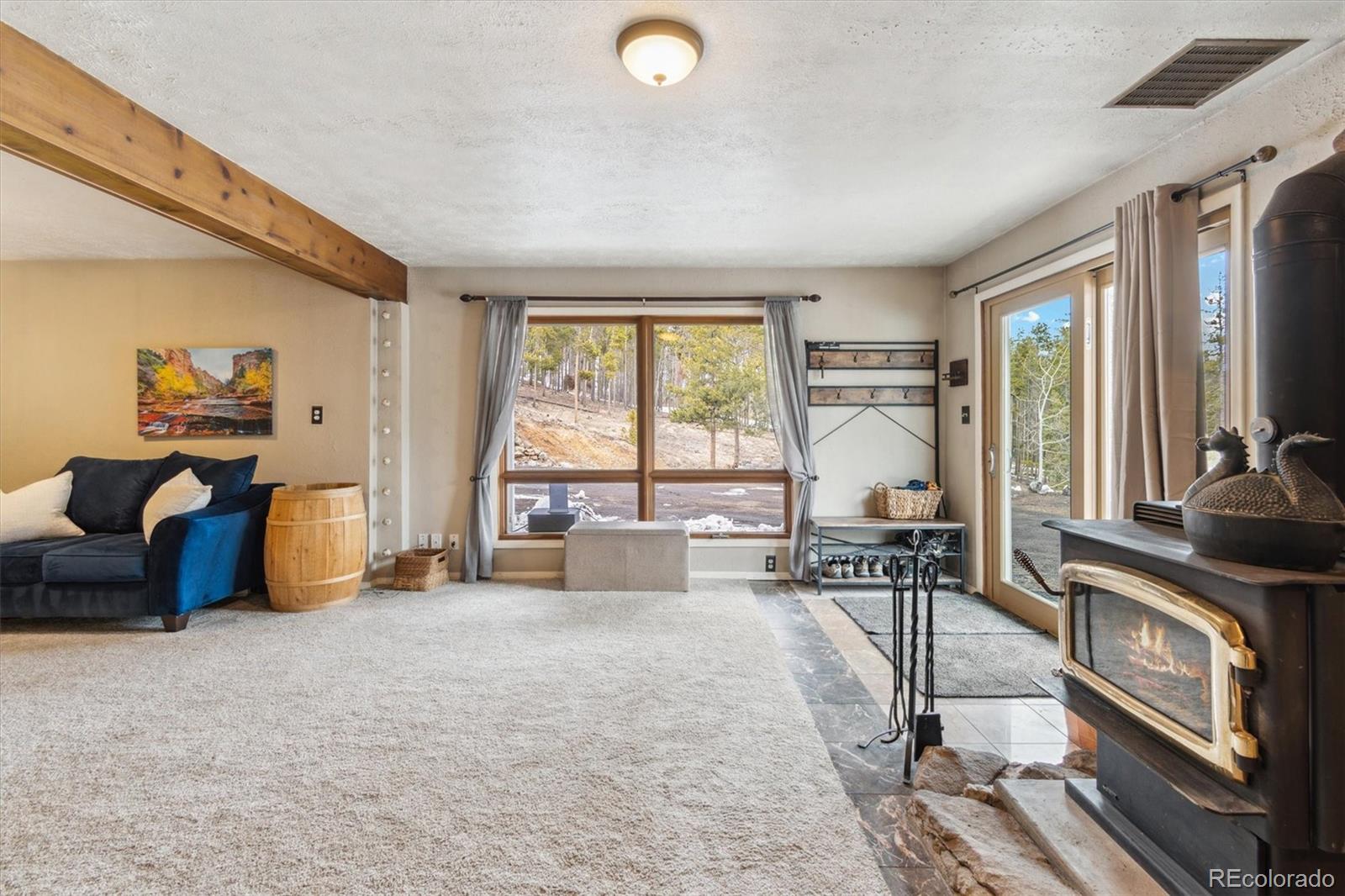 779 Aspen Way Evergreen, CO 80439 - Photo 23 of 49 a living room with furniture and a large window
