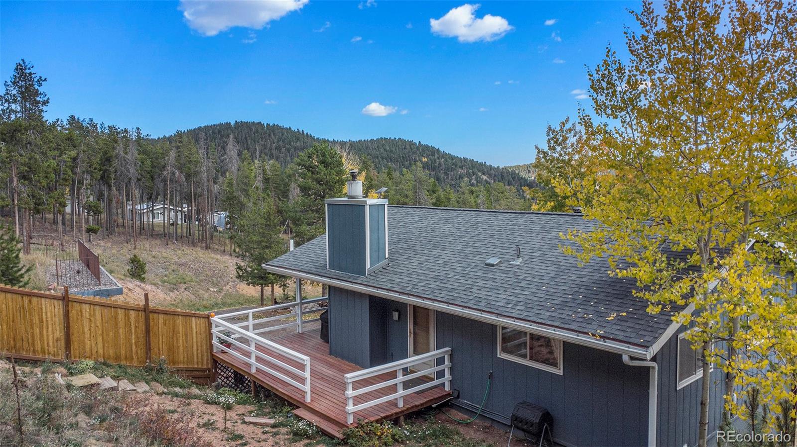 779 Aspen Way Evergreen, CO 80439 - Photo 28 of 49 a view of a terrace with a trees