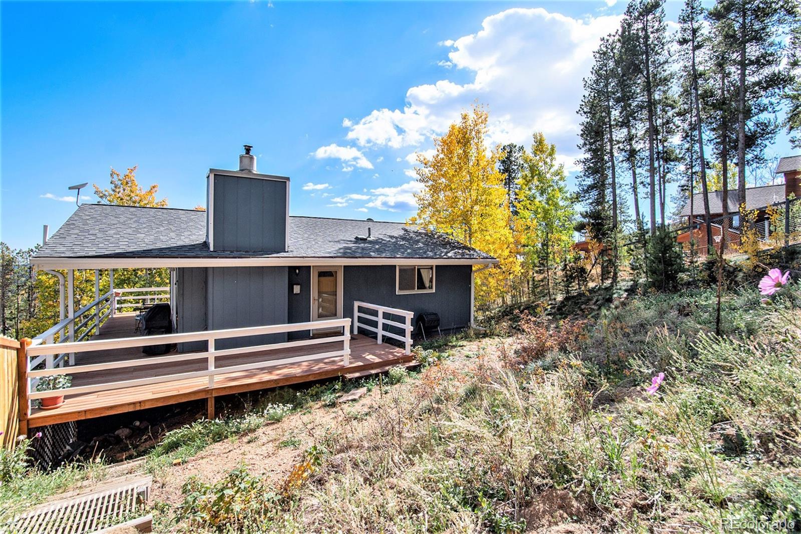 779 Aspen Way Evergreen, CO 80439 - Photo 31 of 49 a view of a house with backyard and sitting area