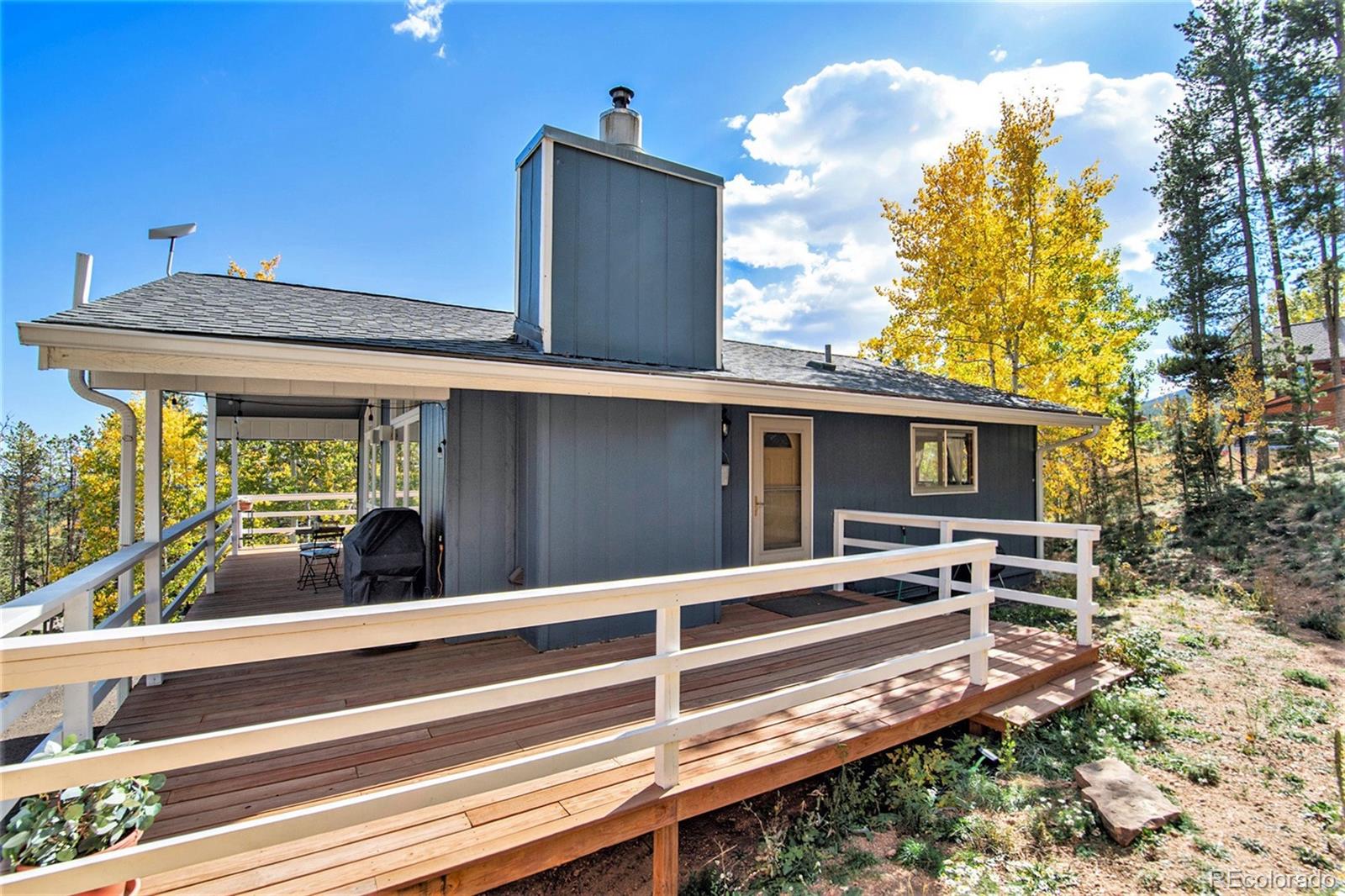 779 Aspen Way Evergreen, CO 80439 - Photo 38 of 49 a view of a house with a large window and wooden fence
