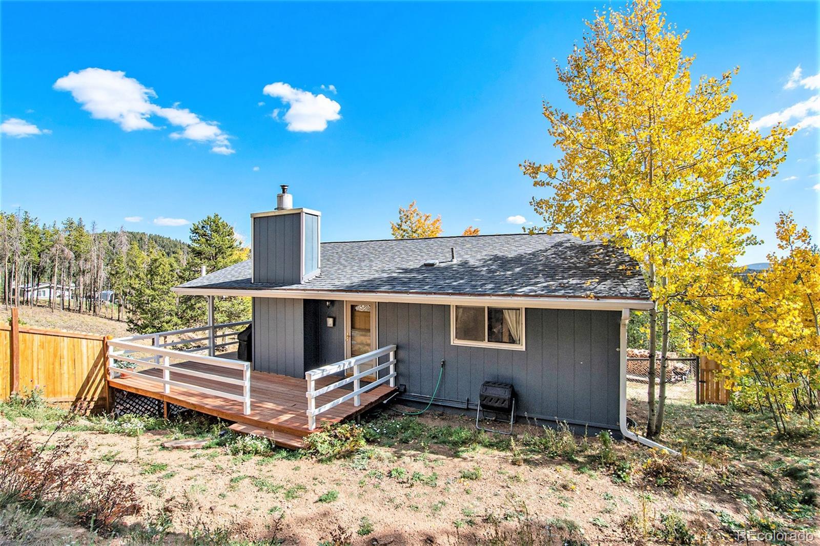 779 Aspen Way Evergreen, CO 80439 - Photo 43 of 49 a backyard of a house with table and chairs
