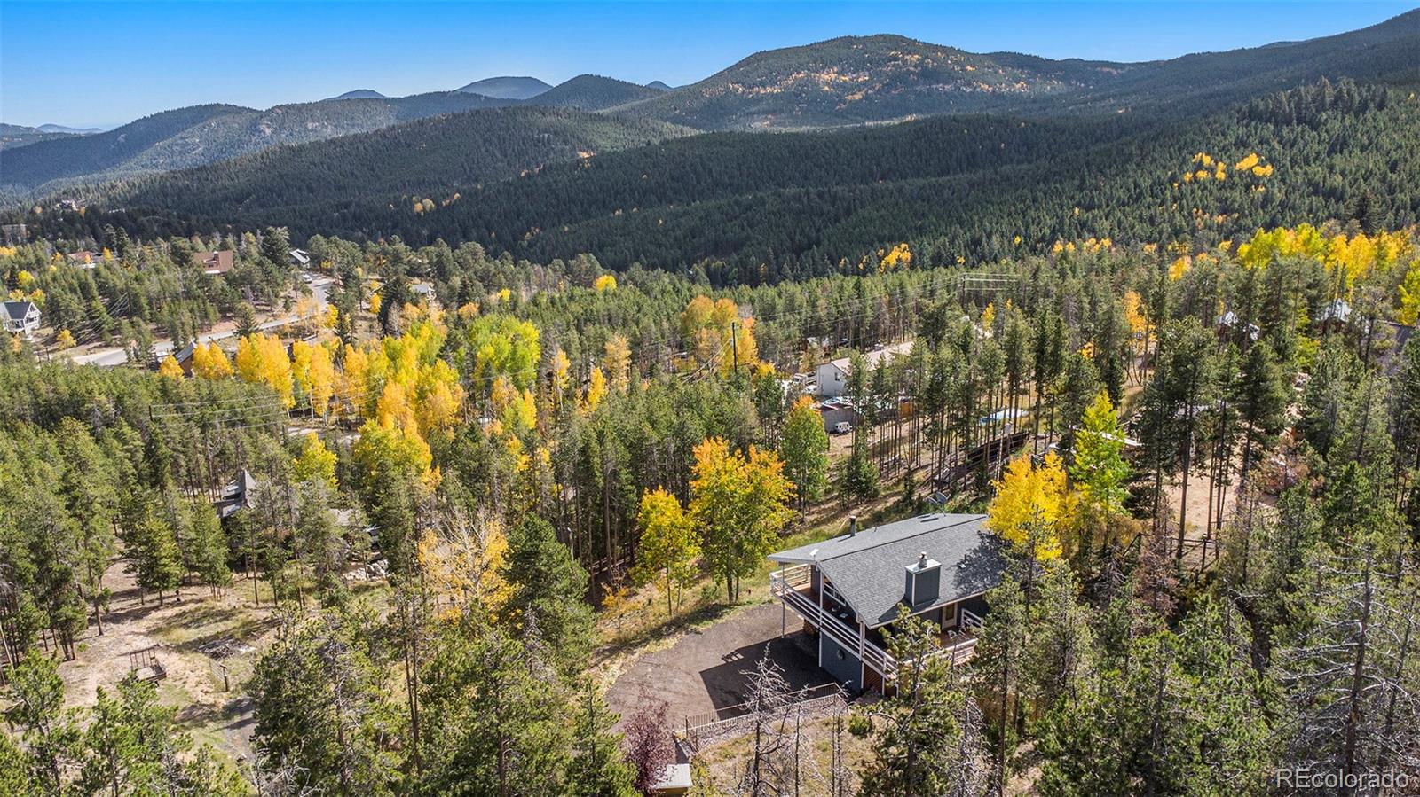 779 Aspen Way Evergreen, CO 80439 - Photo 46 of 49 a view of a lush green hillside and a houses