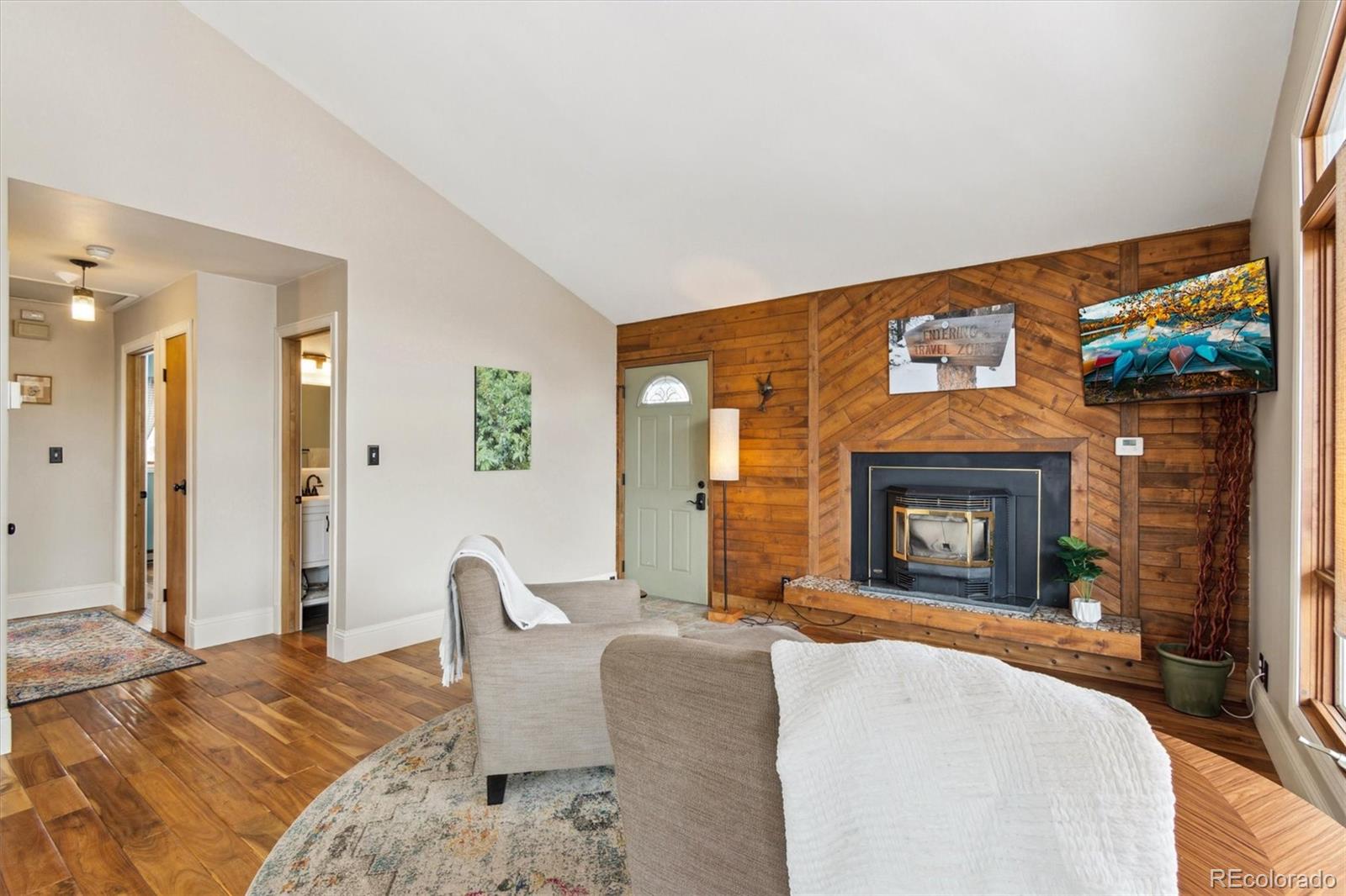 779 Aspen Way Evergreen, CO 80439 - Photo 5 of 49 a bedroom with a bed and a fireplace