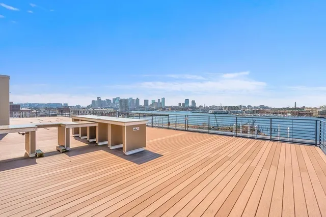 a view of a balcony with wooden floor and city view