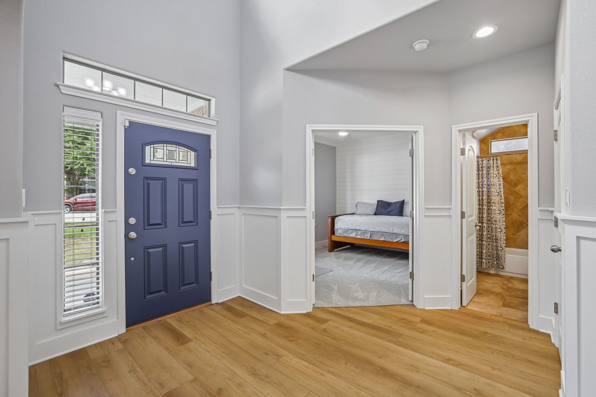 2023 Nelson Ranch Loop Cedar Park, TX 78613 - Photo 5 of 40 A welcoming entry features a rich navy door and durable wood-look flooring, leading to inviting interior spaces.