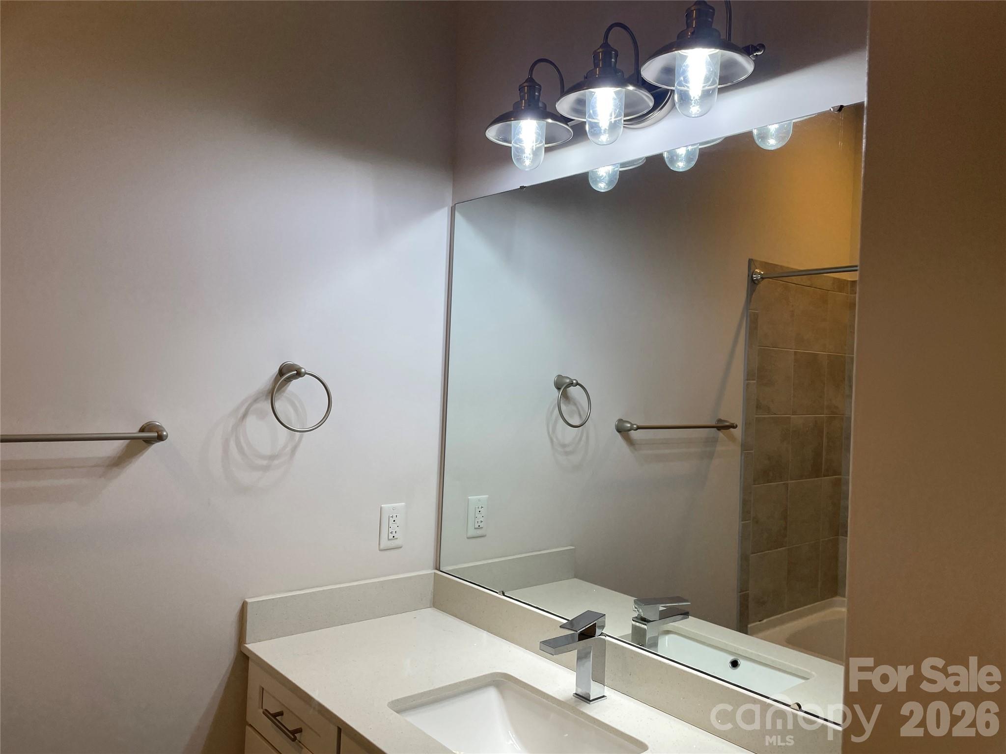 935 McAlway Road, Unit 303 Charlotte, NC 28211 - Photo 13 of 16 a bathroom with a sink mirror and a shower