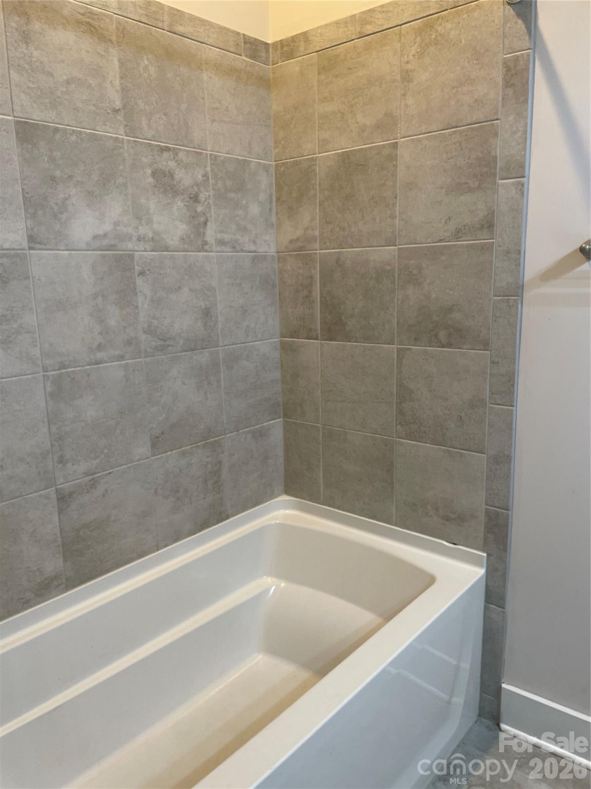 935 McAlway Road, Unit 303 Charlotte, NC 28211 - Photo 14 of 16 a bath tub sitting next to a shower