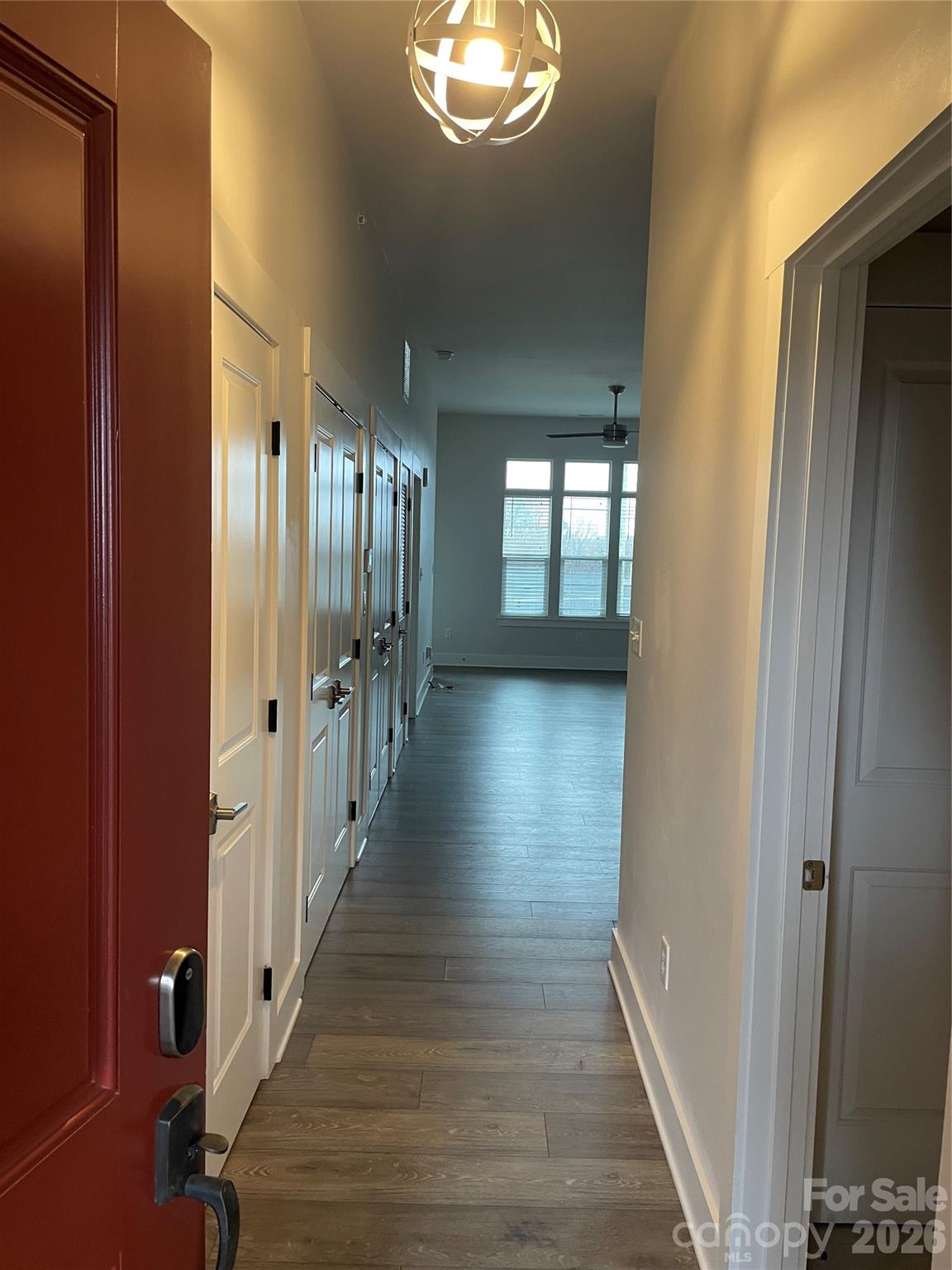 935 McAlway Road, Unit 303 Charlotte, NC 28211 - Photo 3 of 16 a view of a hallway with wooden floor and stairs