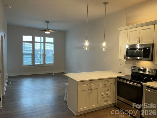 a kitchen with a wooden floor and a stove top oven