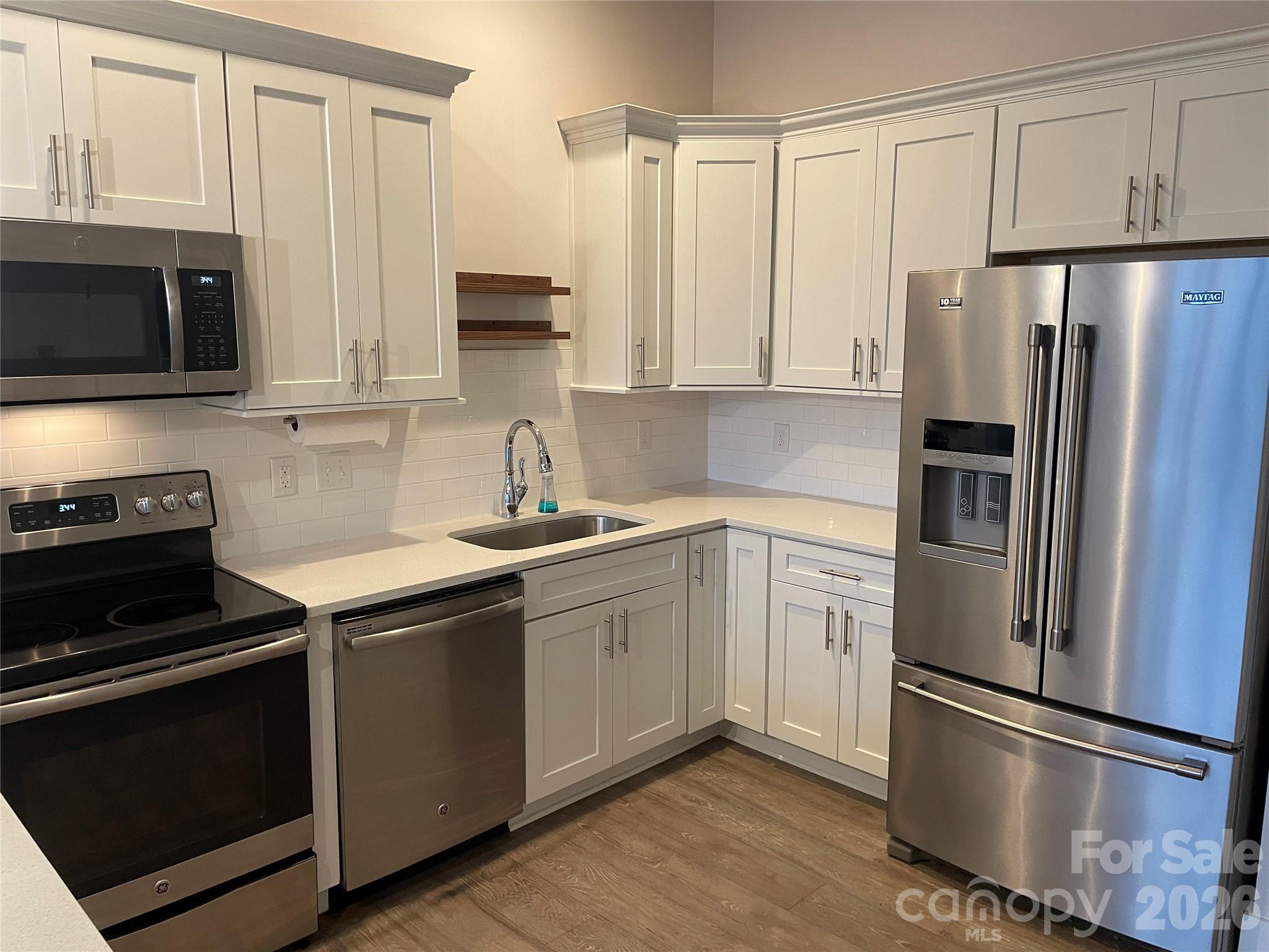 935 McAlway Road, Unit 303 Charlotte, NC 28211 - Photo 5 of 16 a kitchen with a refrigerator stove and microwave