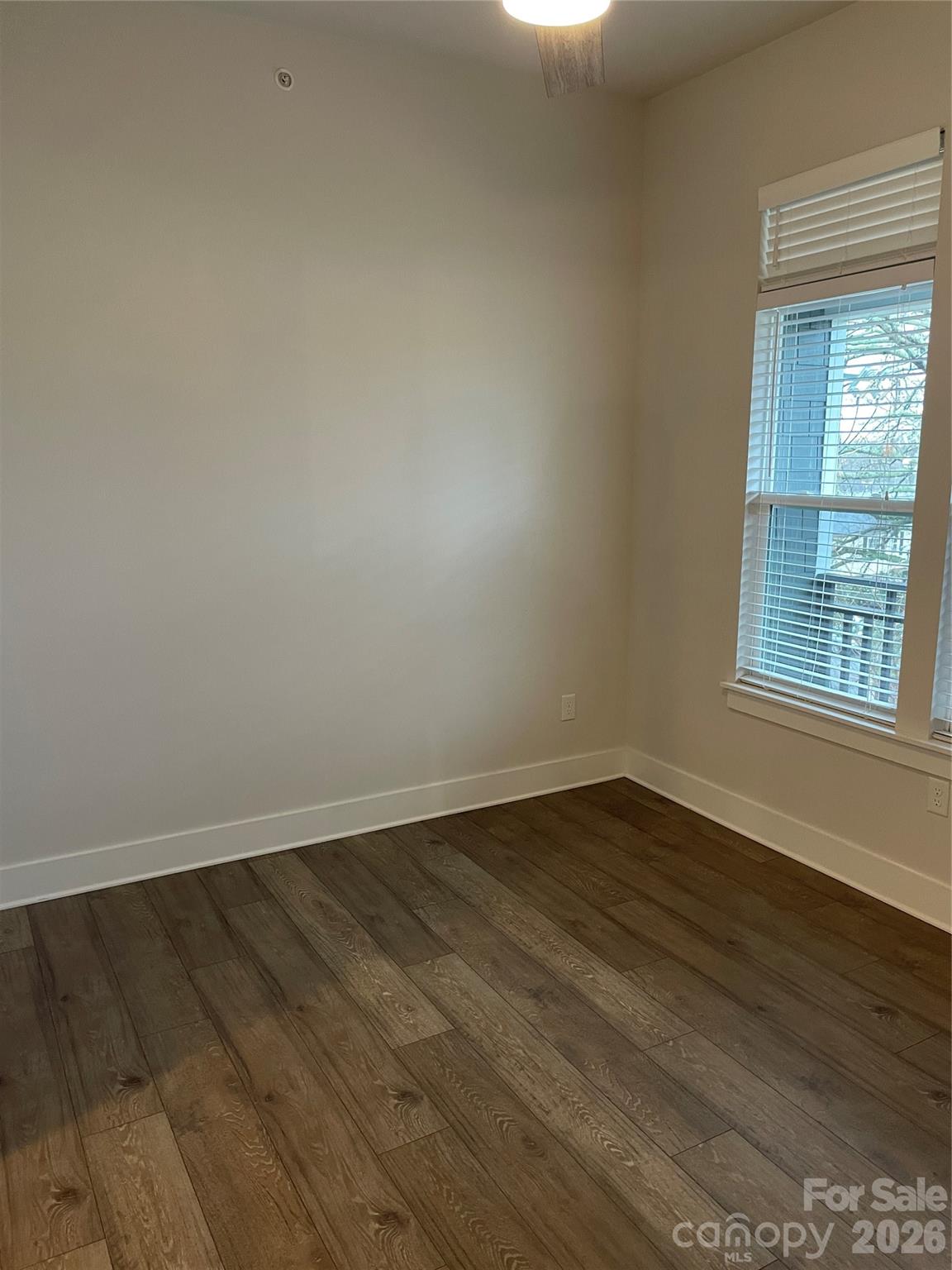 935 McAlway Road, Unit 303 Charlotte, NC 28211 - Photo 7 of 16 wooden floor in an empty room with a window