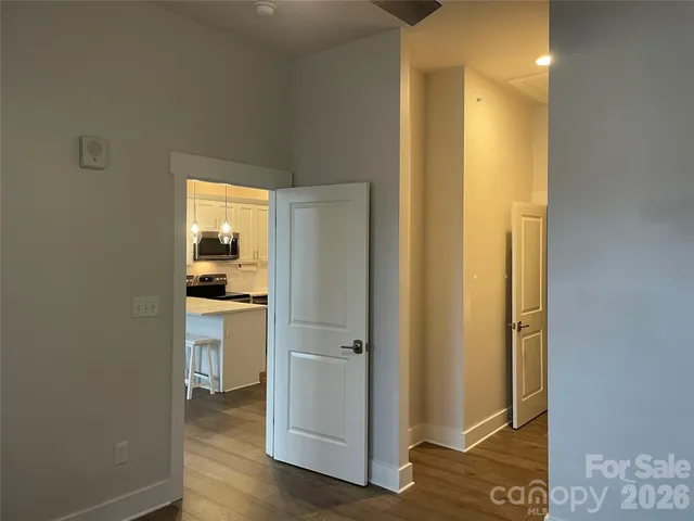 a view of a bathroom with a glass door and a wooden floor
