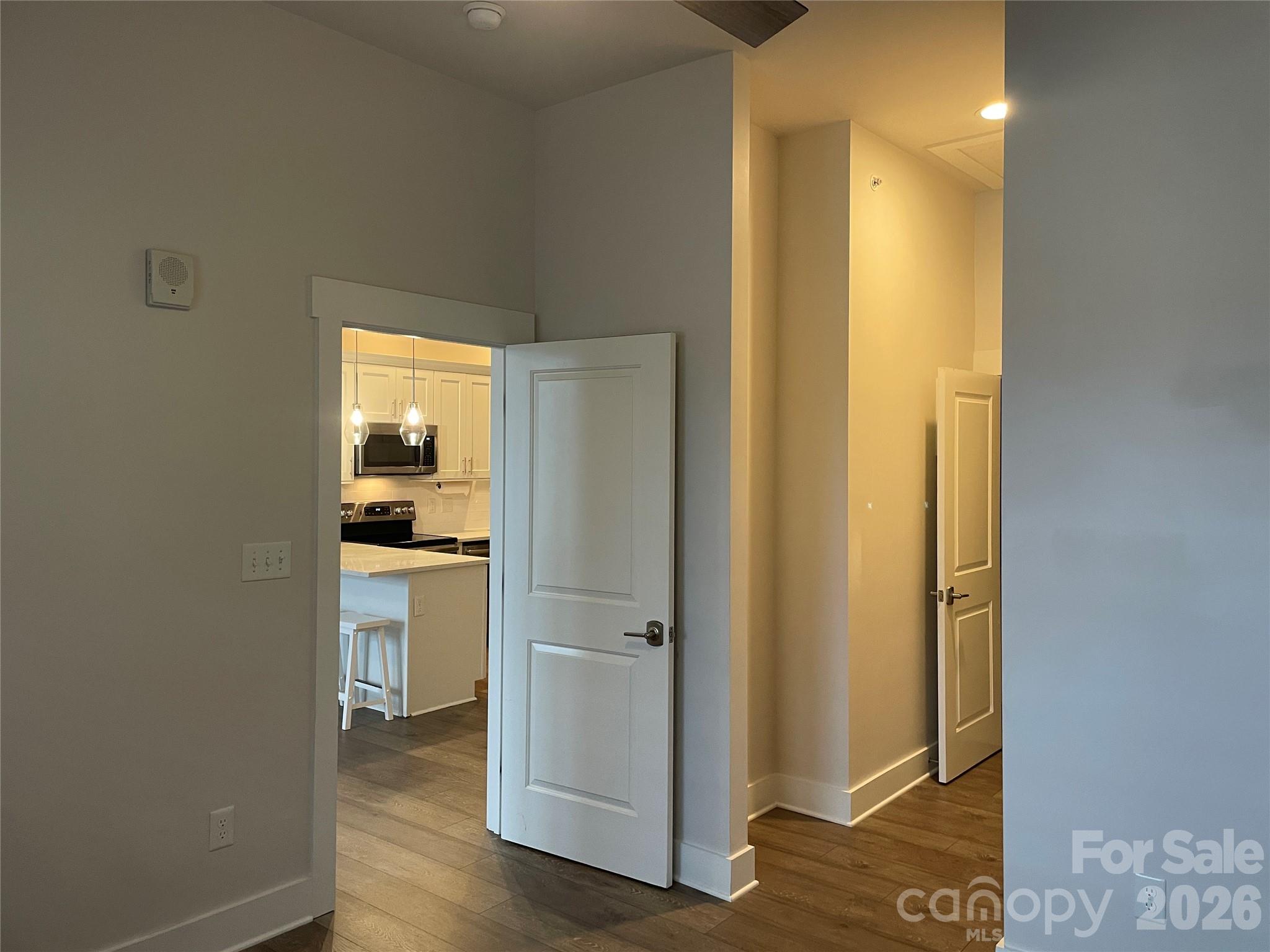 935 McAlway Road, Unit 303 Charlotte, NC 28211 - Photo 8 of 16 a view of a bathroom with a glass door and a wooden floor