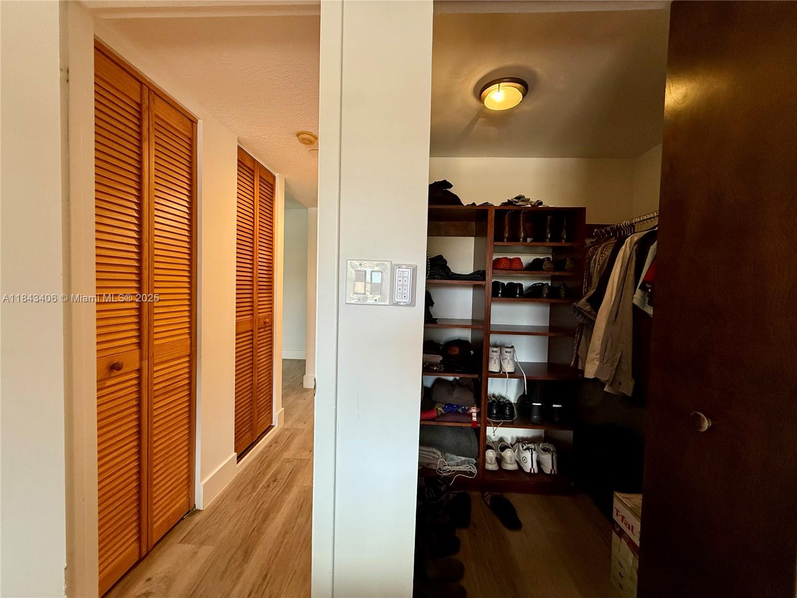 480 Northwest 20th Street, Unit 207 Boca Raton, FL 33431 - Photo 11 of 26 a view of a hallway with wooden shelves