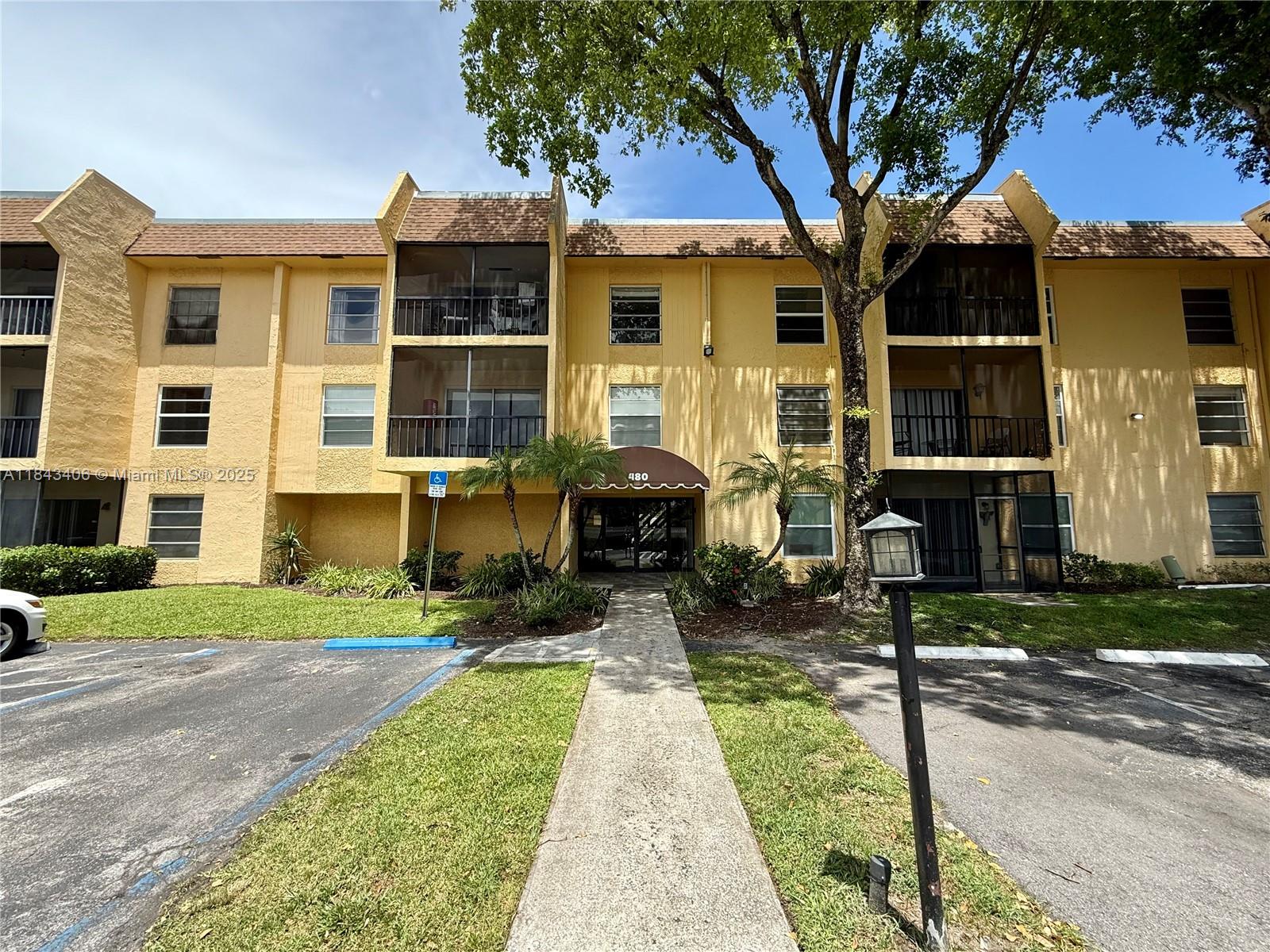 480 Northwest 20th Street, Unit 207 Boca Raton, FL 33431 - Photo 16 of 26 a front view of a house with a yard