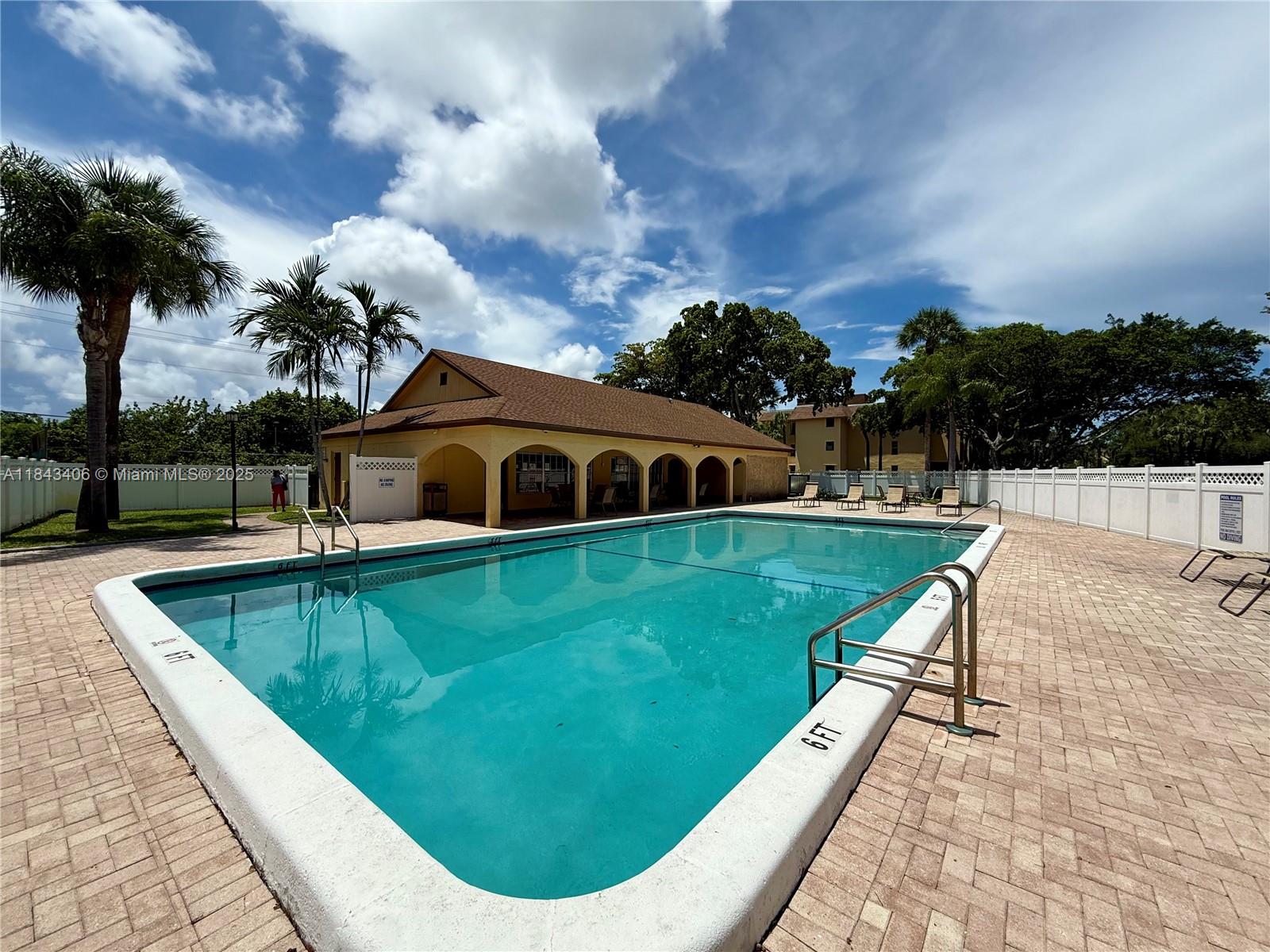 480 Northwest 20th Street, Unit 207 Boca Raton, FL 33431 - Photo 18 of 26 a view of a house with a swimming pool