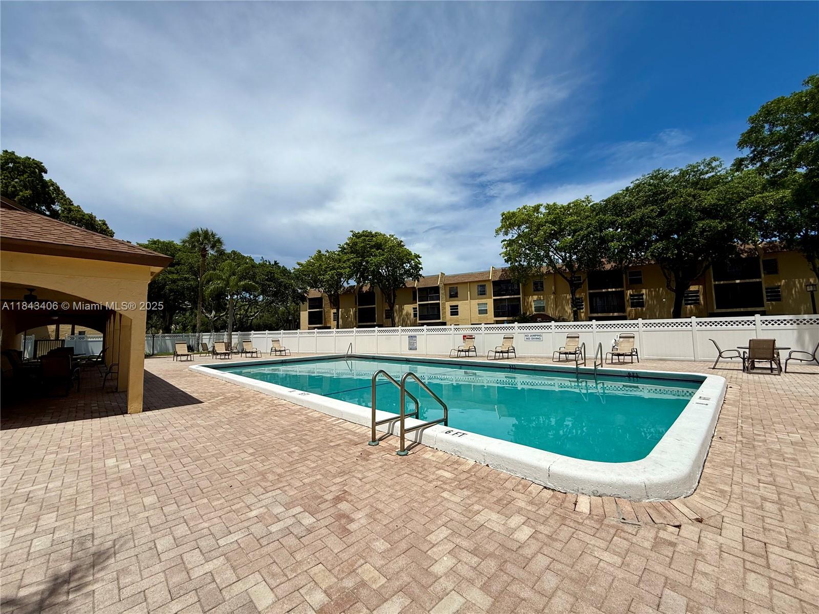 480 Northwest 20th Street, Unit 207 Boca Raton, FL 33431 - Photo 19 of 26 a swimming pool with outdoor seating and yard