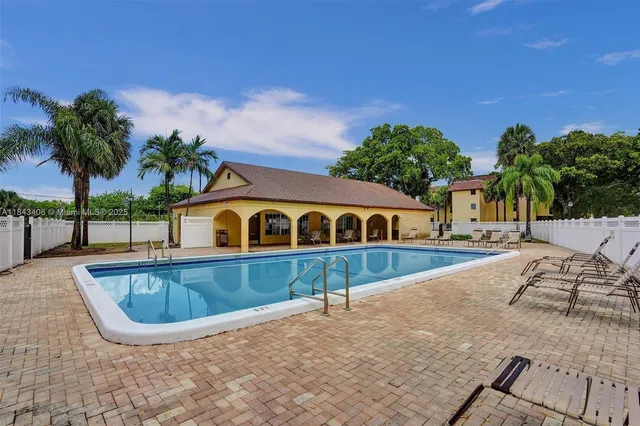 a view of swimming pool with outdoor seating and plants